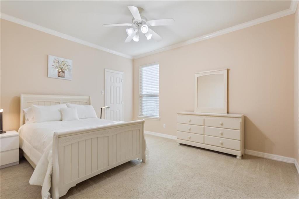 5620 Landsdown Drive Waco, TX 76708 - Photo 22 of 37 a bedroom with a bed and a chandelier