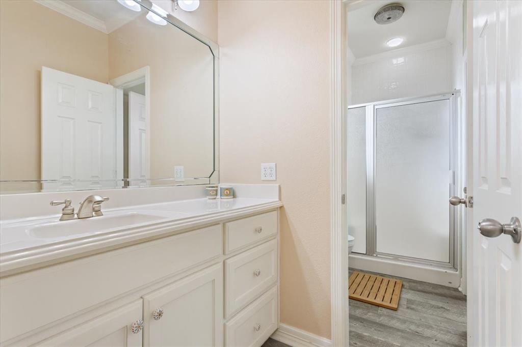 5620 Landsdown Drive Waco, TX 76708 - Photo 23 of 37 a bathroom with a double vanity sink and mirror