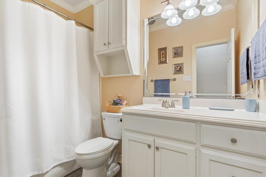 5620 Landsdown Drive Waco, TX 76708 - Photo 25 of 37 a bathroom with a toilet sink and mirror