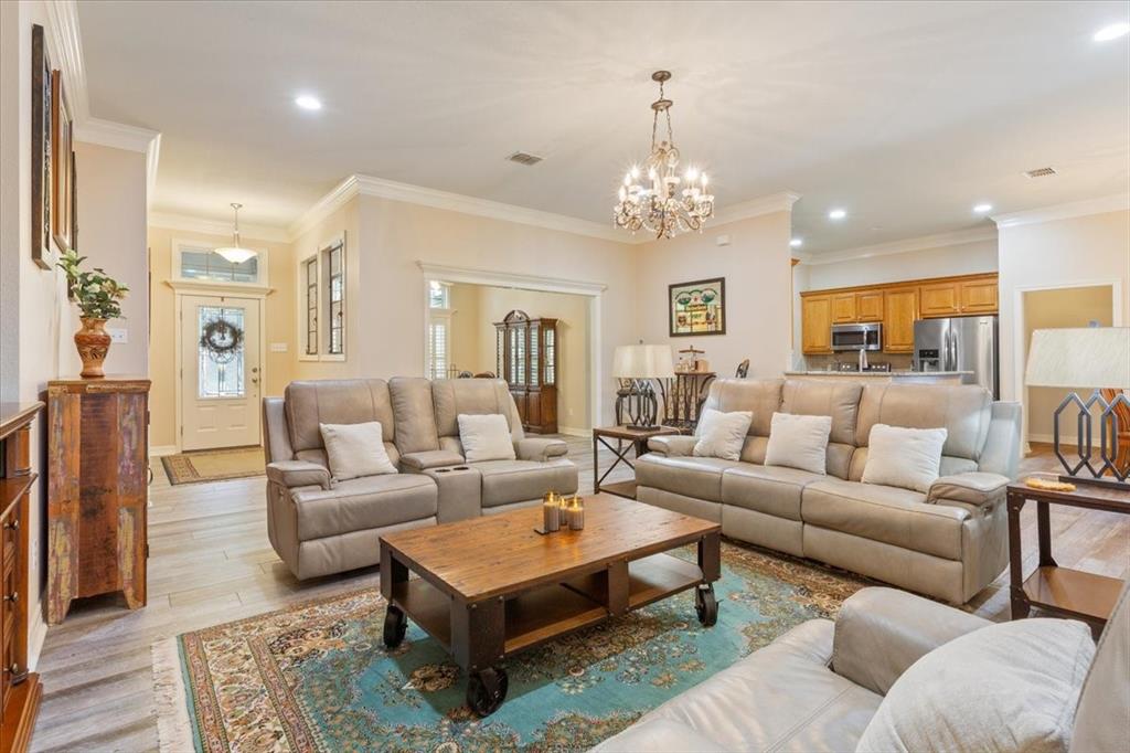 5620 Landsdown Drive Waco, TX 76708 - Photo 7 of 37 a living room with furniture a rug and a chandelier