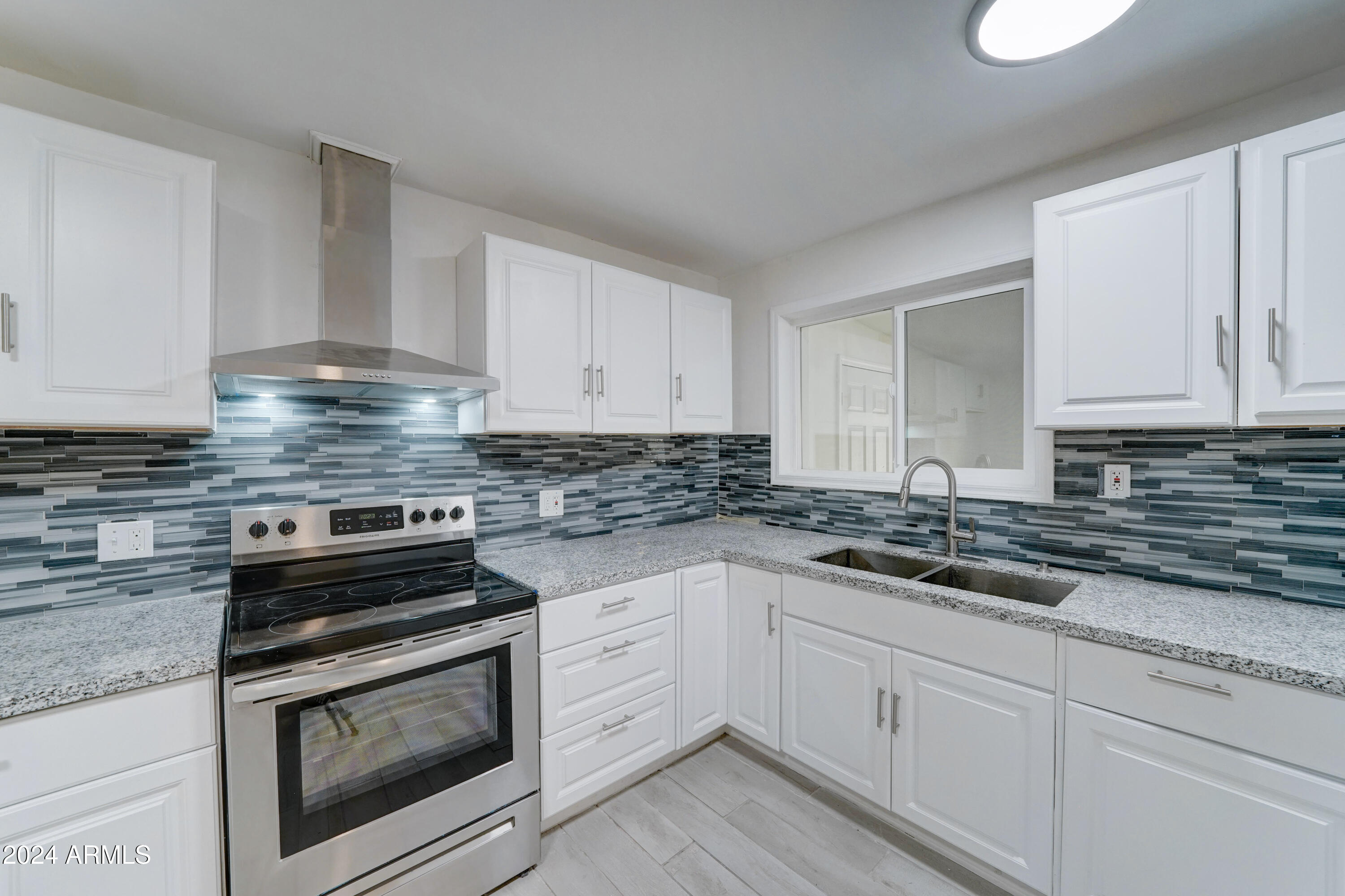 4522 North 14th Avenue Phoenix, AZ 85013 - Photo 12 of 36 a kitchen with granite countertop white cabinets and white appliances