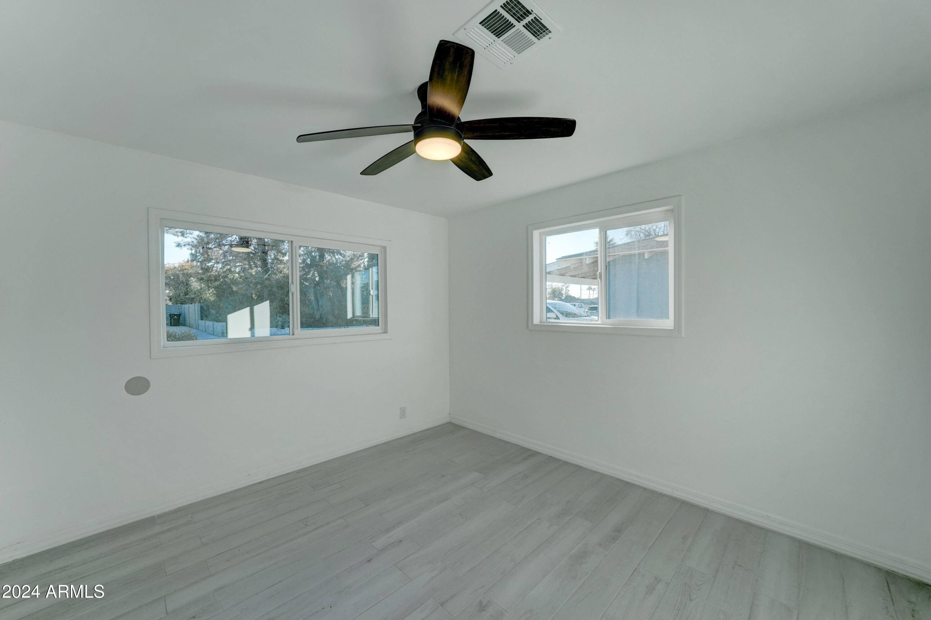 4522 North 14th Avenue Phoenix, AZ 85013 - Photo 20 of 36 a view of an empty room with wooden floor and window