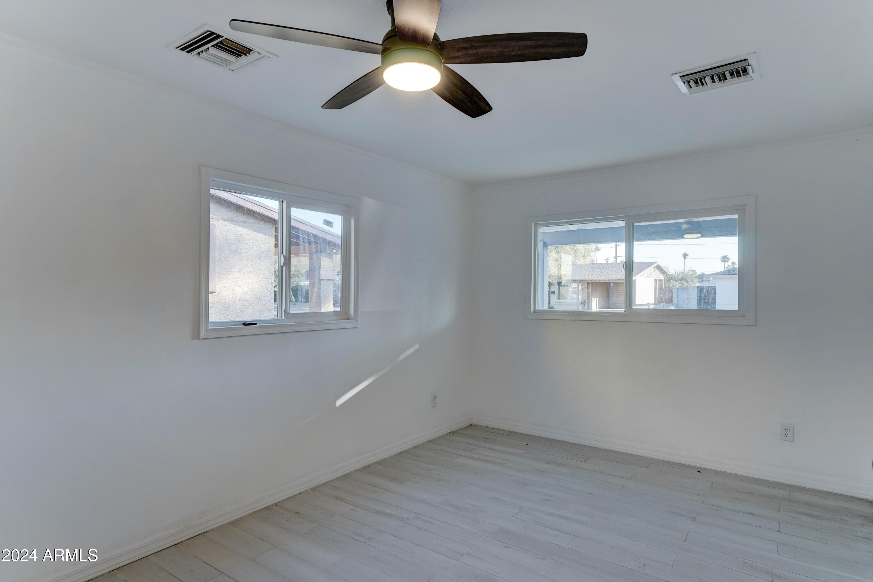 4522 North 14th Avenue Phoenix, AZ 85013 - Photo 25 of 36 an empty room with windows and fan