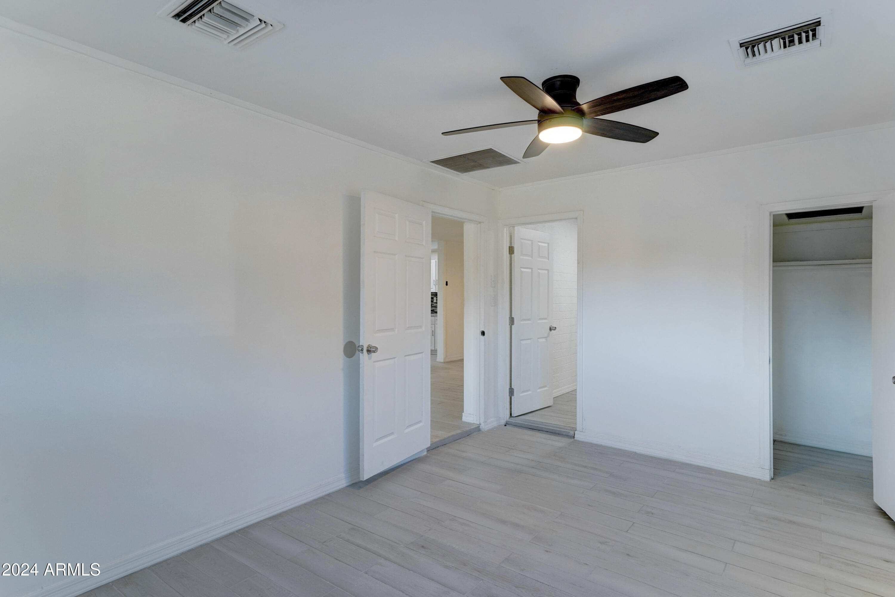 4522 North 14th Avenue Phoenix, AZ 85013 - Photo 26 of 36 a view of empty room with wooden floor and ceiling fan