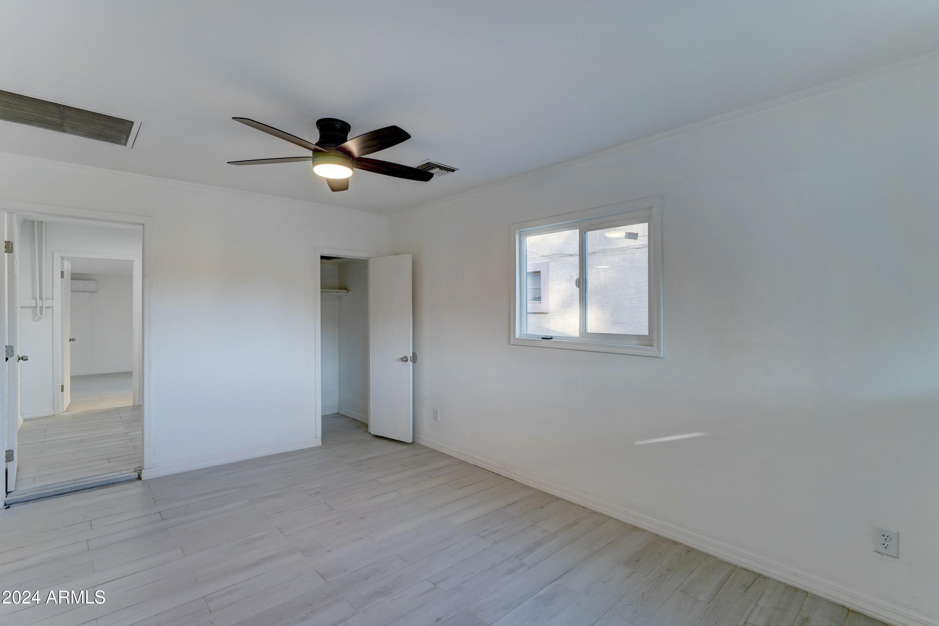 4522 North 14th Avenue Phoenix, AZ 85013 - Photo 27 of 36 an empty room with a window and a ceiling fan