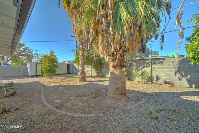 a backyard of a house with table and chairs