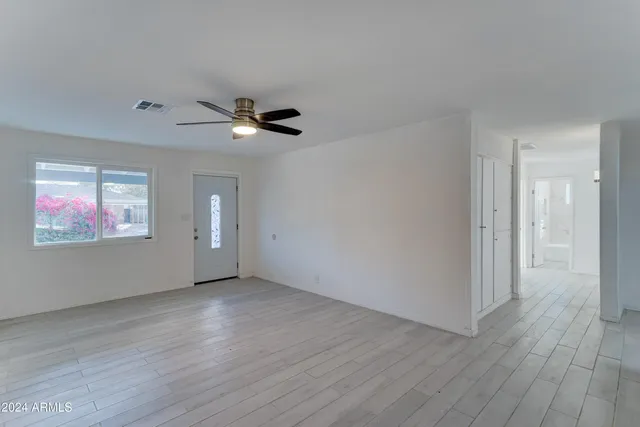 a view of an empty room with wooden floor
