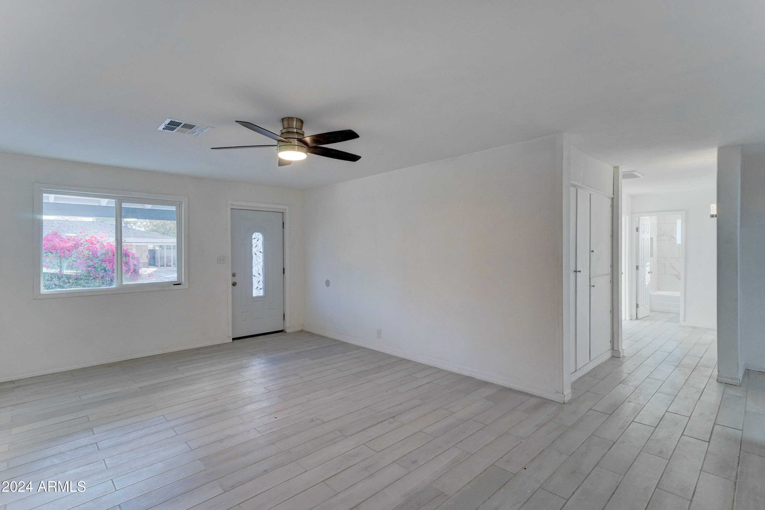 4522 North 14th Avenue Phoenix, AZ 85013 - Photo 4 of 36 a view of an empty room with wooden floor