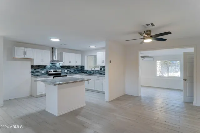 a kitchen with granite countertop a sink and cabinets