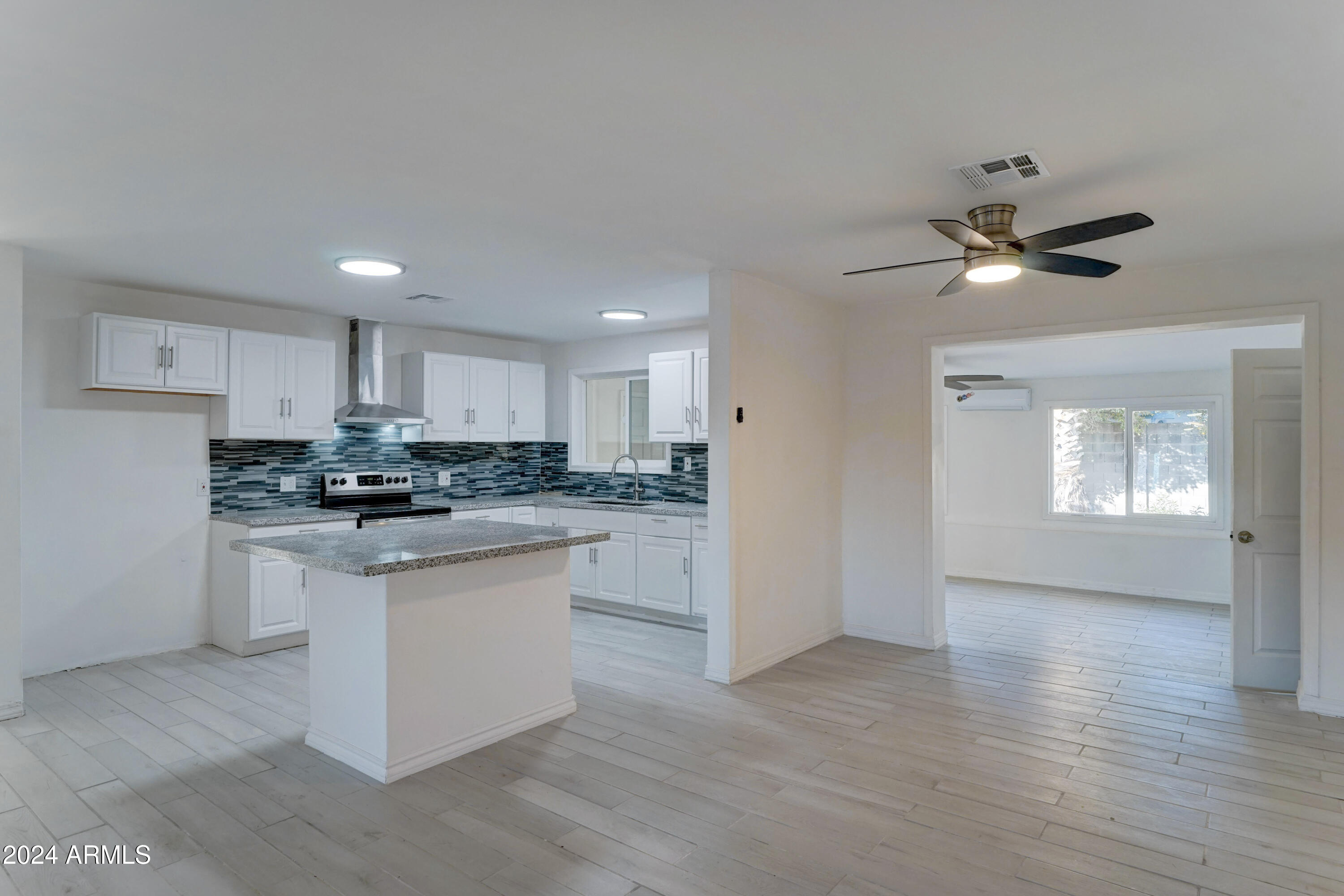 4522 North 14th Avenue Phoenix, AZ 85013 - Photo 8 of 36 a kitchen with white cabinets and white appliances
