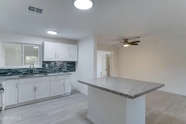 a kitchen with stainless steel appliances granite countertop a stove and a granite counter tops