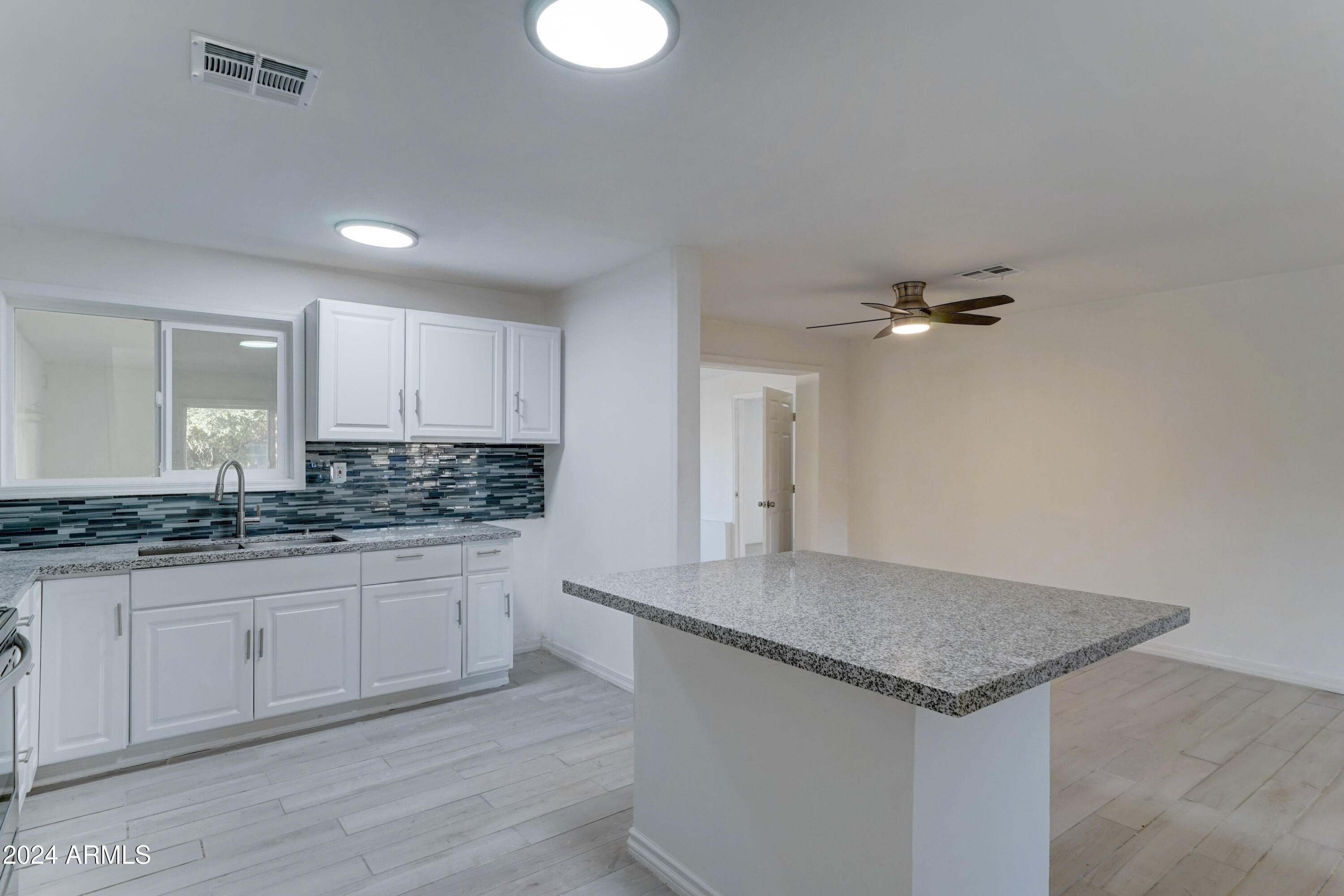 4522 North 14th Avenue Phoenix, AZ 85013 - Photo 9 of 36 a kitchen with granite countertop a sink and cabinets