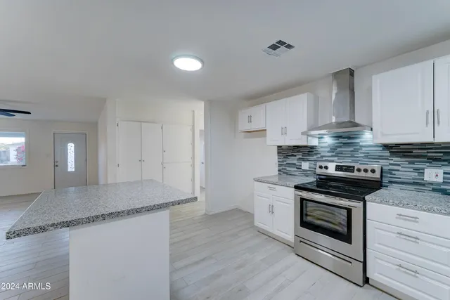 a kitchen with granite countertop a sink and a stove