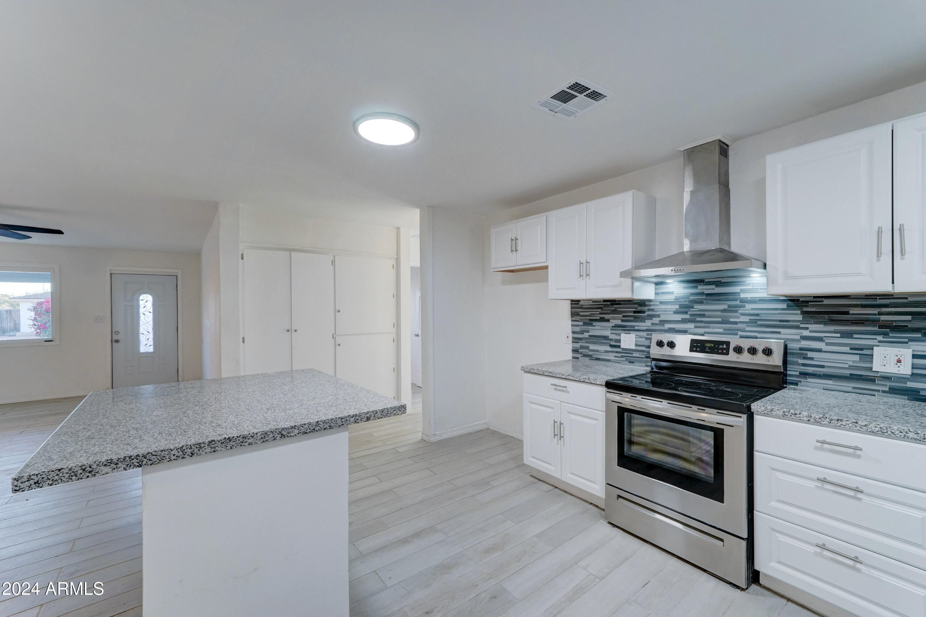 4522 North 14th Avenue Phoenix, AZ 85013 - Photo 10 of 36 a kitchen with stainless steel appliances granite countertop a stove and a granite counter tops
