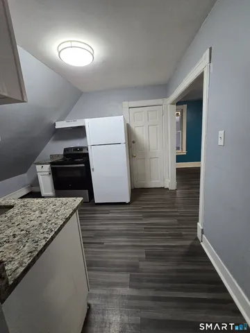 a view of kitchen cabinets and wooden floor