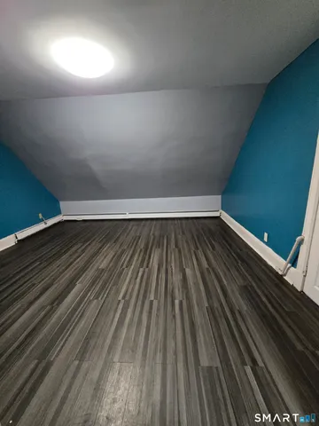 a view of room with wooden floor