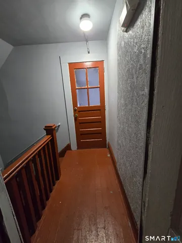 a view of a hallway with stairs
