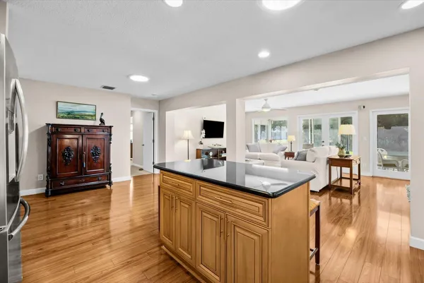 a kitchen with stainless steel appliances granite countertop a sink stove and wooden floor