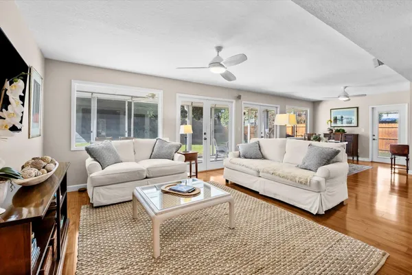 a living room with furniture a large window and a rug