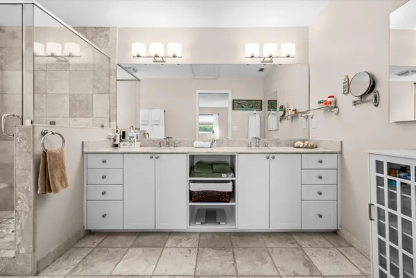 a bathroom with a double vanity sink mirror and double