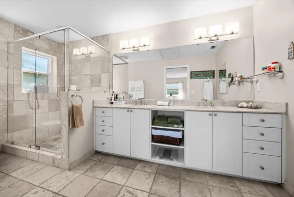 a bathroom with a sink a toilet and a mirror