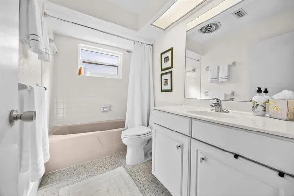 a bedroom with two beds and a table