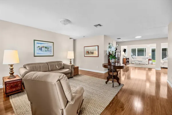 a living room with furniture and a wooden floor
