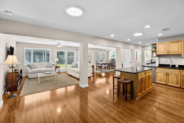 a large open kitchen with a large window and stainless steel appliances
