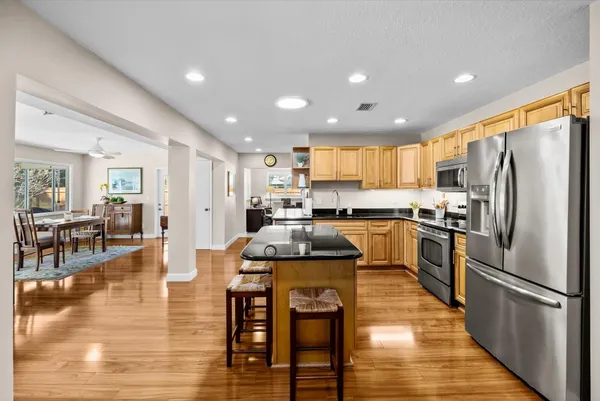 a kitchen with a refrigerator a counter top space and a center island