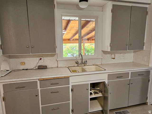 744 Royal Street Helper, UT 84526 - Photo 11 of 33 Kitchen with gray cabinets, light countertops, and tasteful backsplash