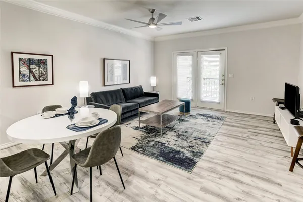 a living room with furniture and wooden floor