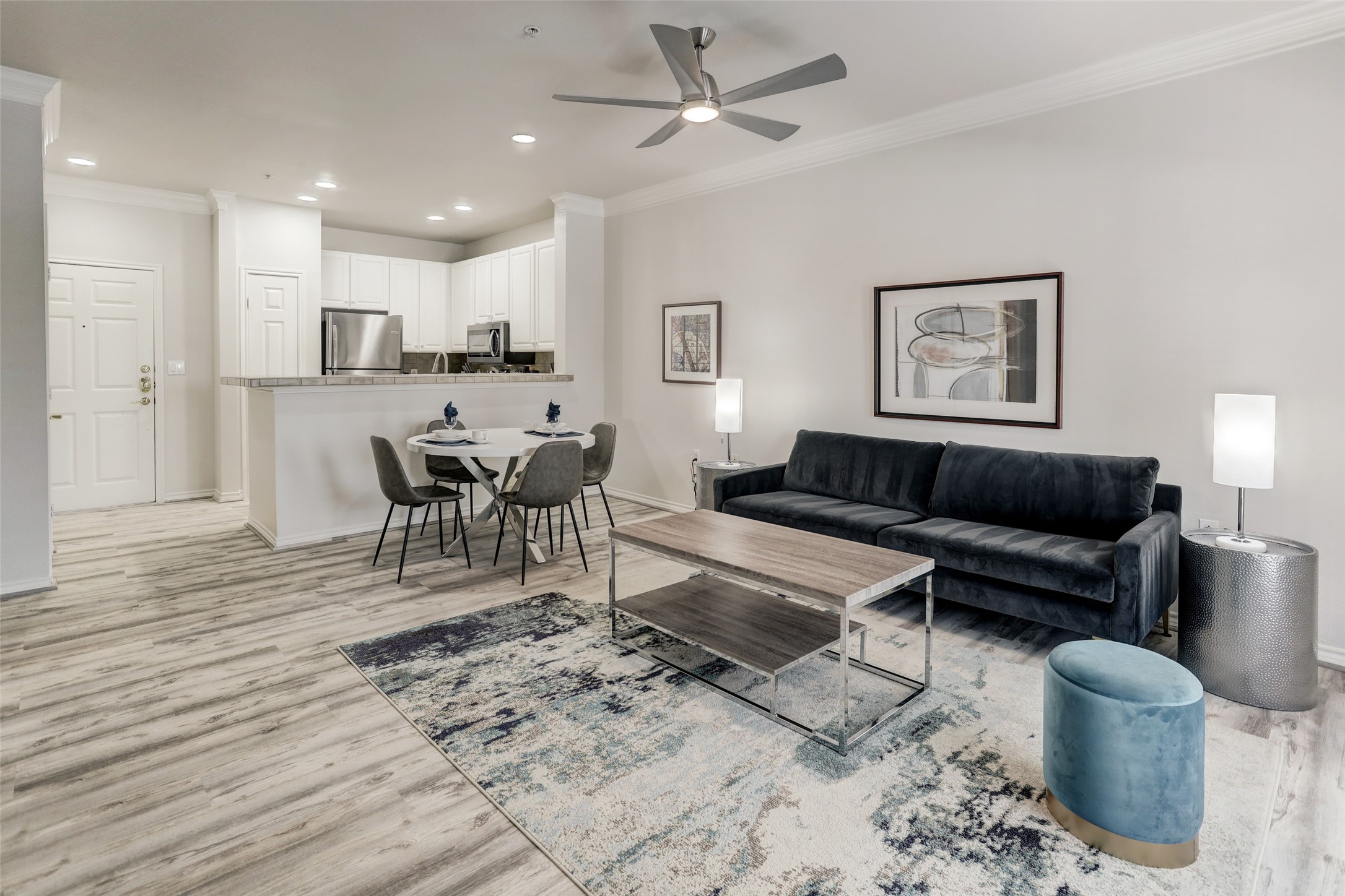2400 McCue Road, Unit 346 Houston, TX 77056 - Photo 3 of 10 a living room with furniture a view of dining room and wooden floor