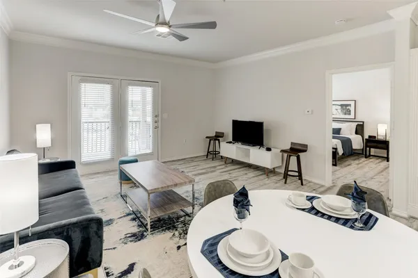 a room with furniture a flat screen tv and a window