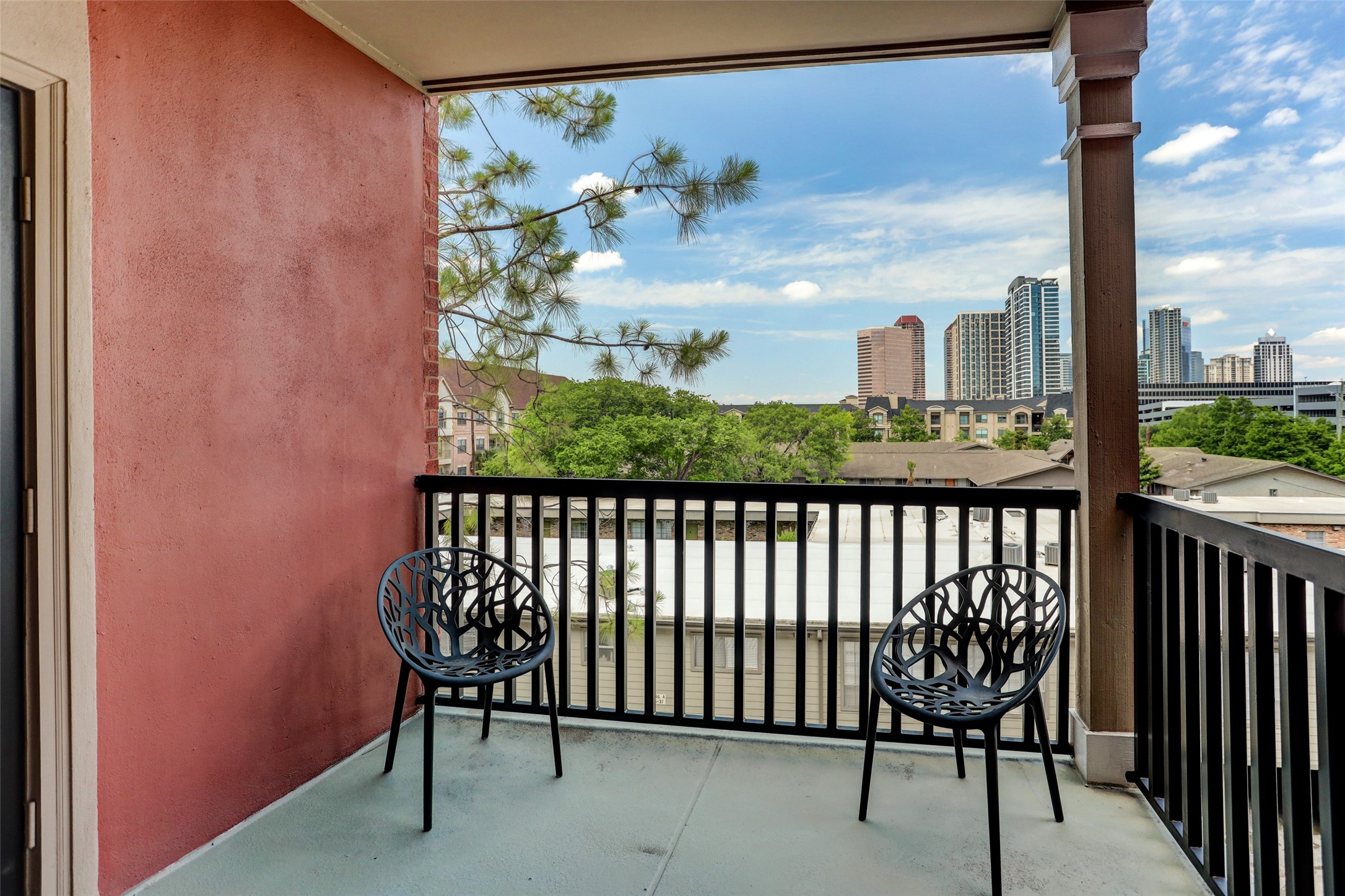 2400 McCue Road, Unit 346 Houston, TX 77056 - Photo 9 of 10 a view of a balcony with table and chairs and wooden fence