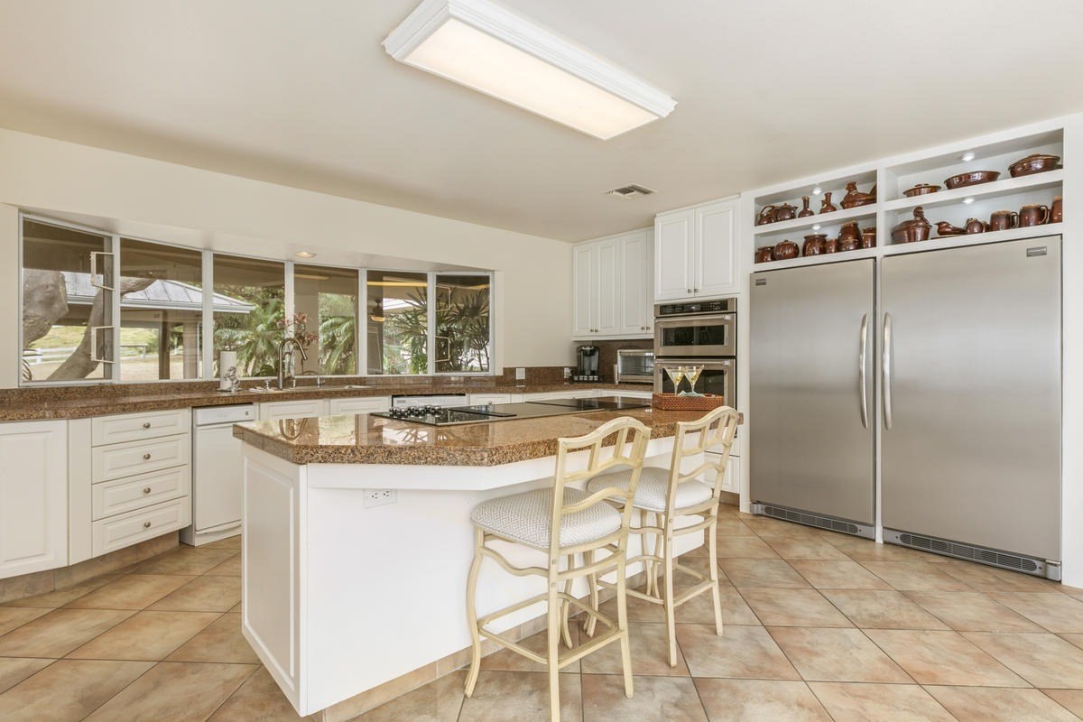 59-1764 Kohala Ranch Road Kamuela, HI 96743 - Photo 14 of 30 a kitchen with stainless steel appliances granite countertop a stove and a refrigerator