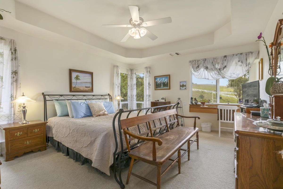 59-1764 Kohala Ranch Road Kamuela, HI 96743 - Photo 17 of 30 a spacious bedroom with a bed a table and chair