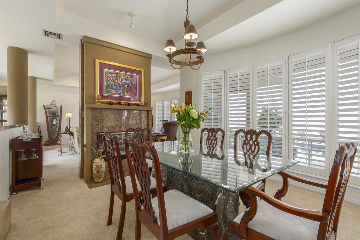 59-1764 Kohala Ranch Road Kamuela, HI 96743 - Photo 7 of 30 a view of a dining room with furniture a chandelier and wooden floor