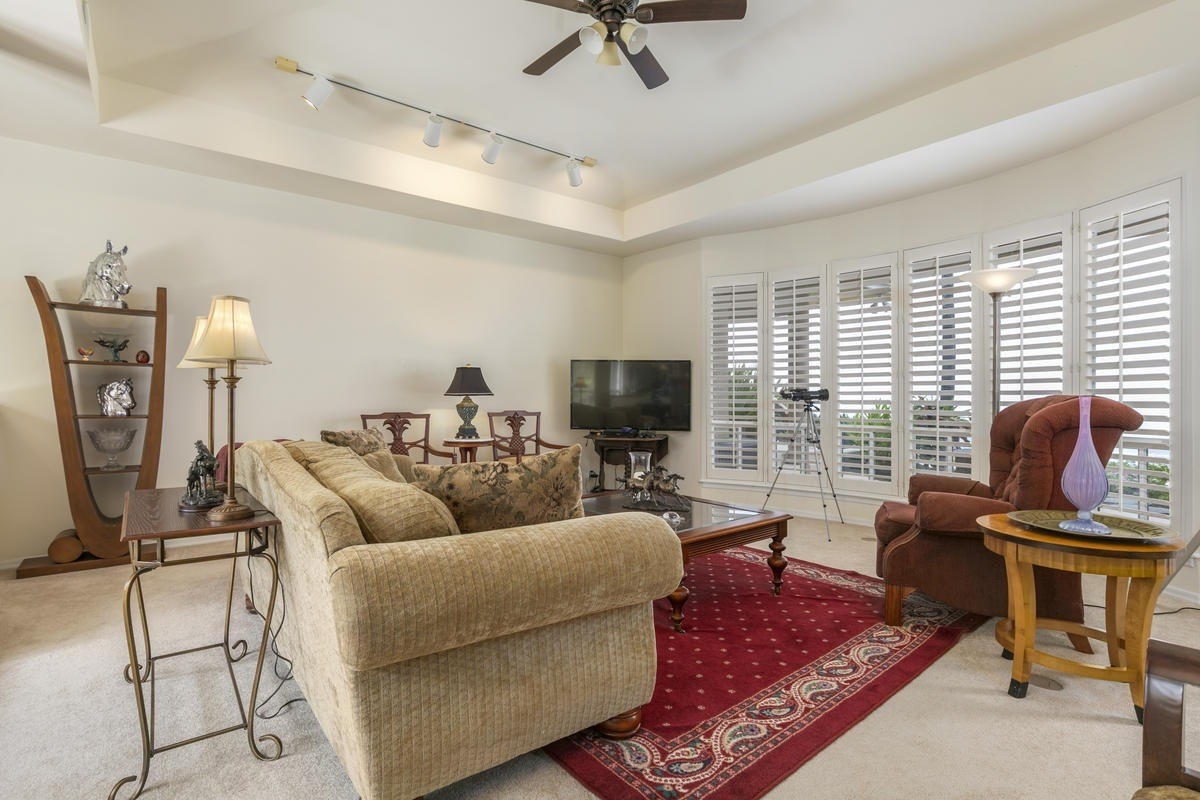 59-1764 Kohala Ranch Road Kamuela, HI 96743 - Photo 8 of 30 a living room with furniture a flat screen tv and a large window