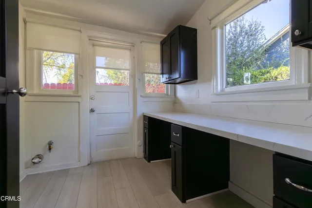 a kitchen with stainless steel appliances cabinets a window and a sink