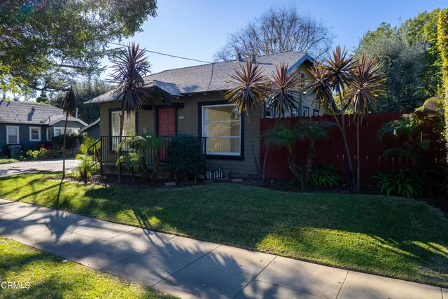 a front view of a house with a yard table and chairs