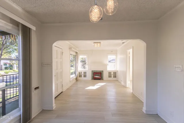 a view of a livingroom with wooden floor and a large window