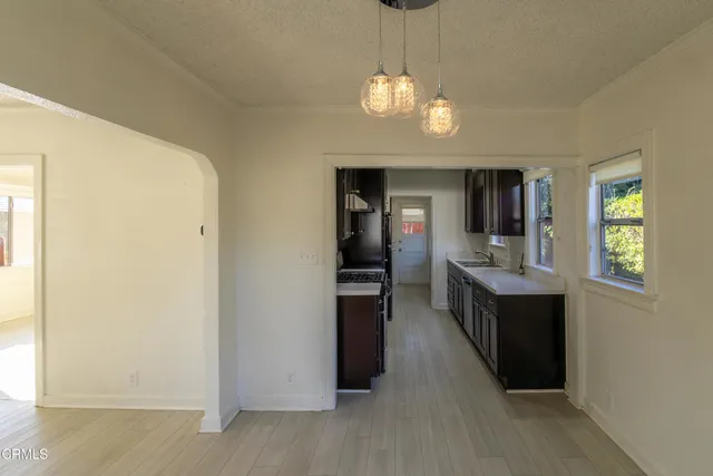 a open kitchen with a refrigerator and dishwasher