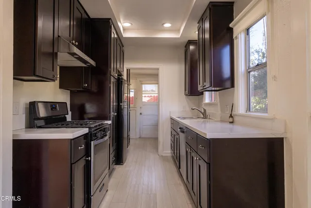 a kitchen with a sink stove and cabinets