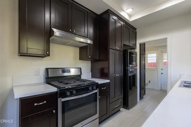 a kitchen with stainless steel appliances granite countertop a stove and a refrigerator