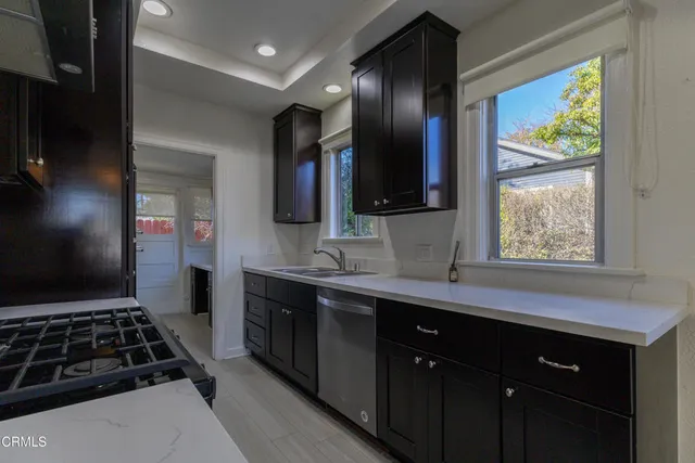 a kitchen with stainless steel appliances a sink stove and refrigerator