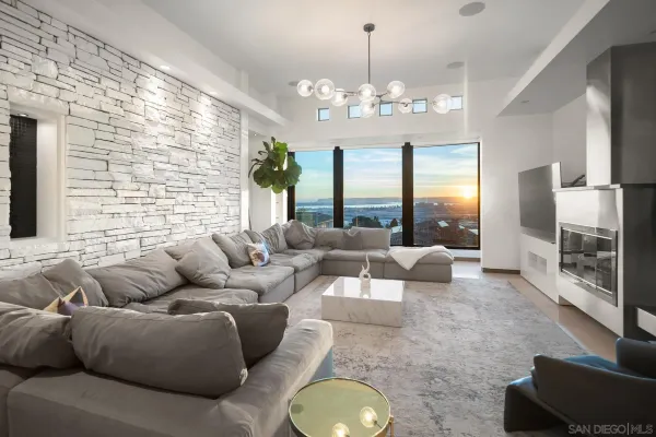 a living room with fireplace furniture and a chandelier