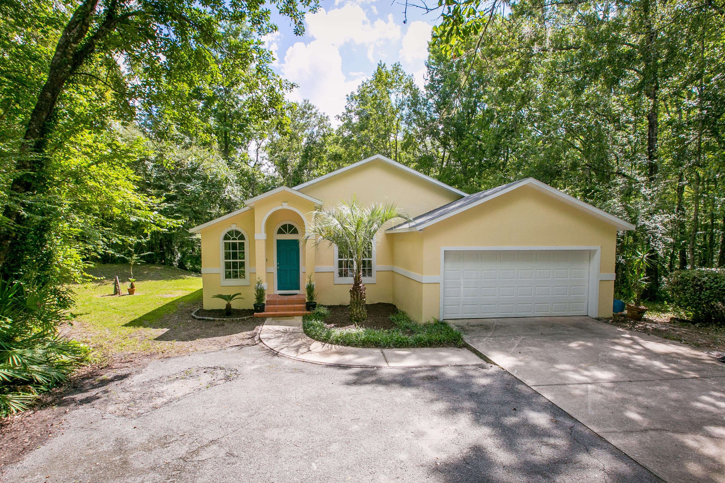 2225 Pacetti Road St. Augustine, FL 32092 - Photo 1 of 42 a front view of a house with a yard and garage