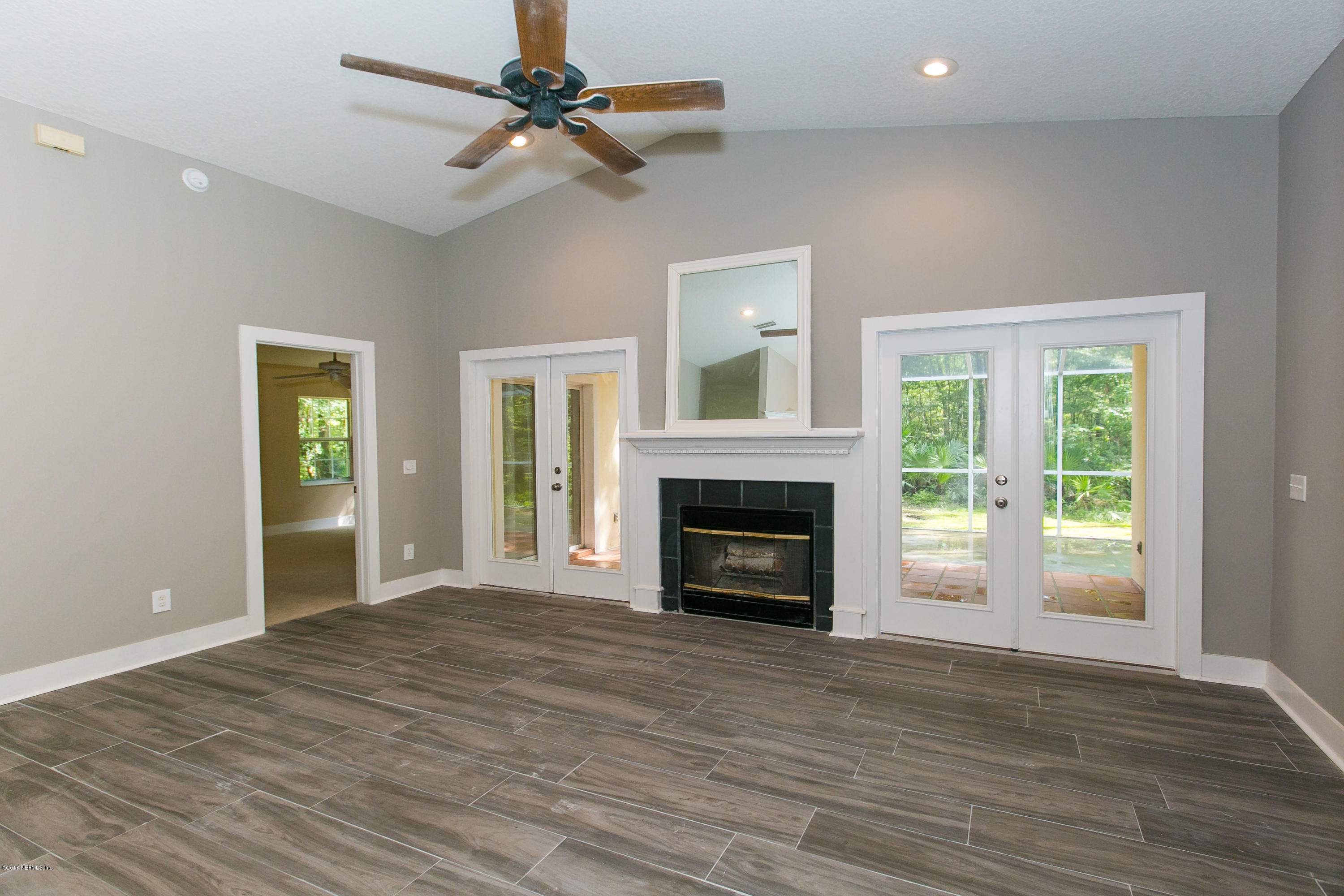 2225 Pacetti Road St. Augustine, FL 32092 - Photo 17 of 42 a view of empty room with wooden floor and fireplace