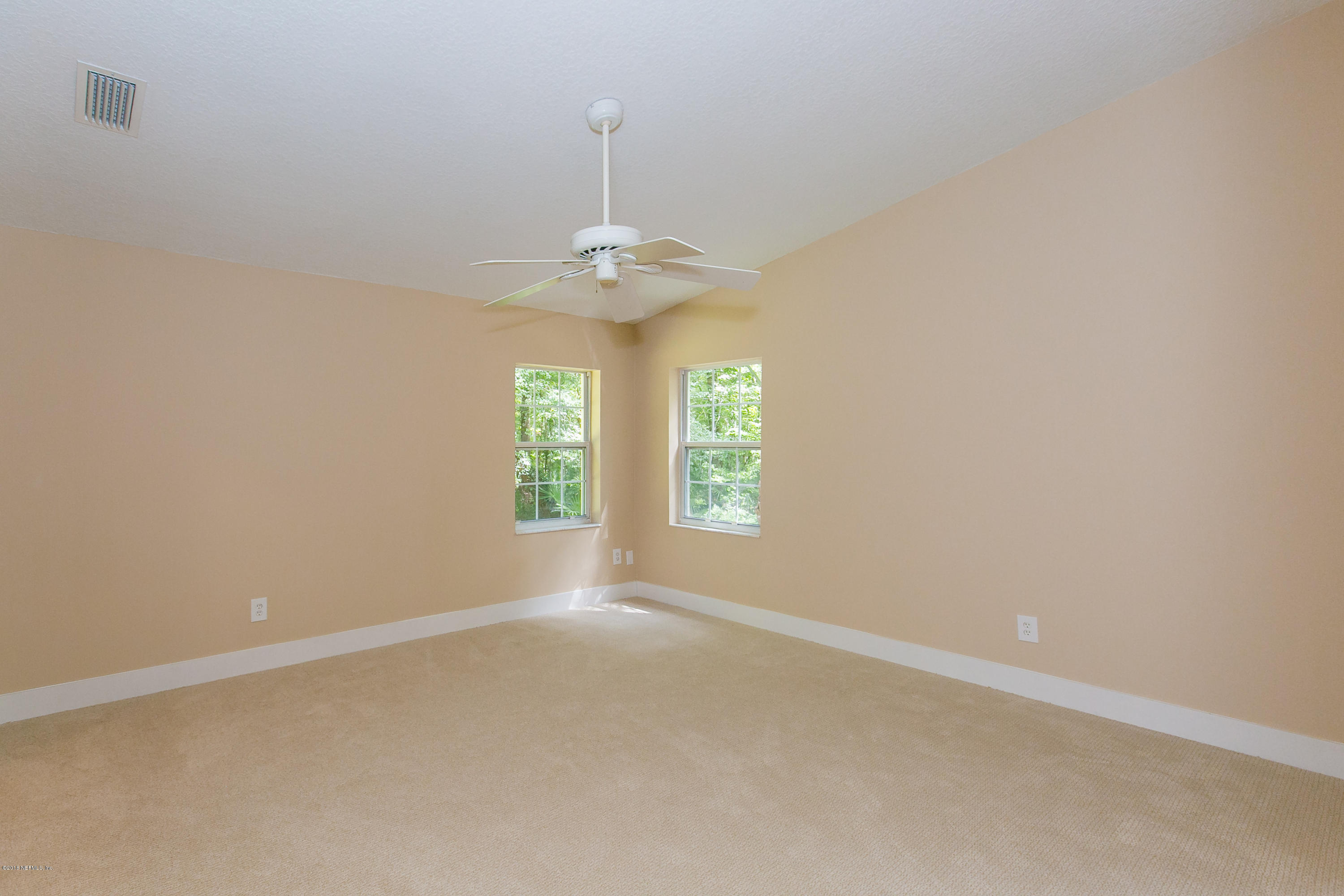 2225 Pacetti Road St. Augustine, FL 32092 - Photo 23 of 42 a view of an empty room with window and chandelier fan