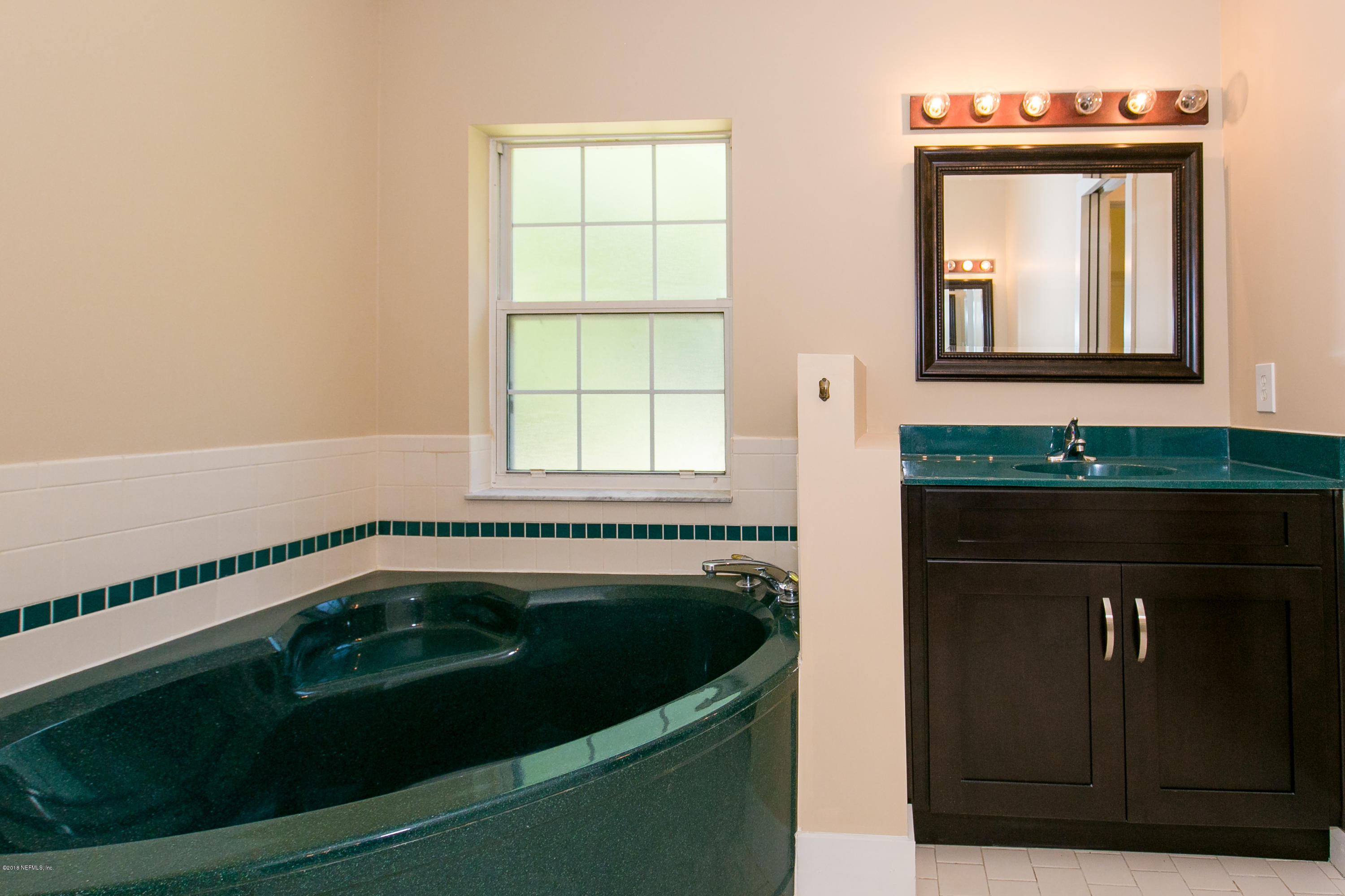 2225 Pacetti Road St. Augustine, FL 32092 - Photo 25 of 42 a bathroom with a sink and a mirror